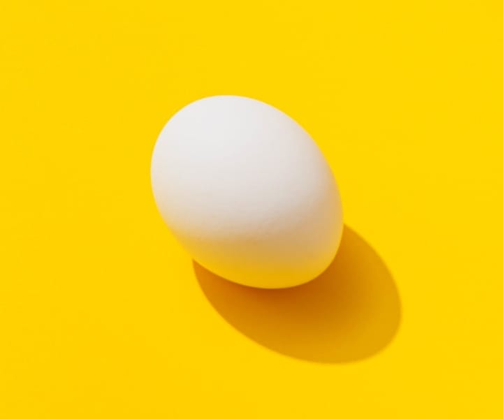 Image of an egg on an yellow background